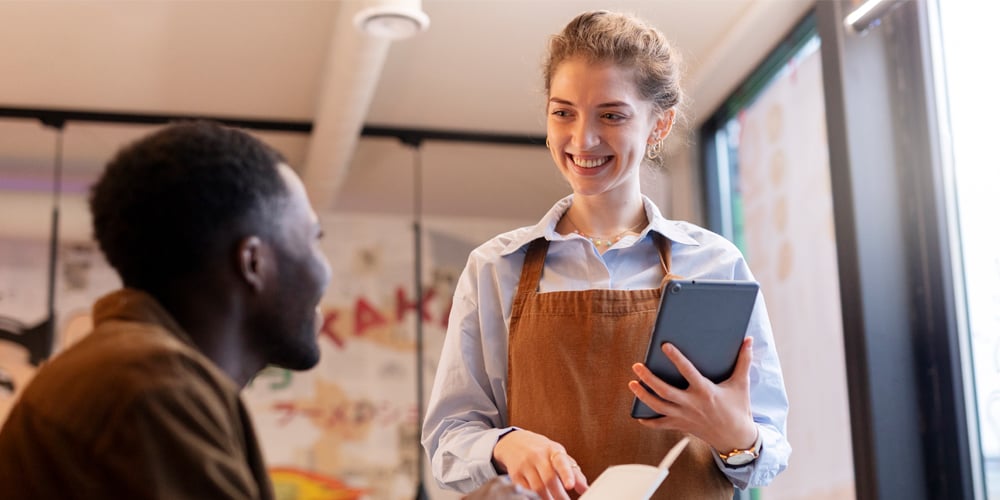 Server taking someone's order at restaurant